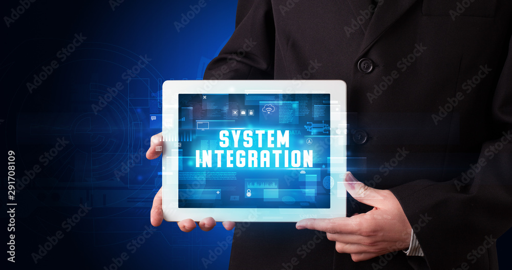 Young business person working on tablet and shows the digital sign: SYSTEM INTEGRATION Young business person working on tablet and shows the digital sign: SYSTEM INTEGRATION