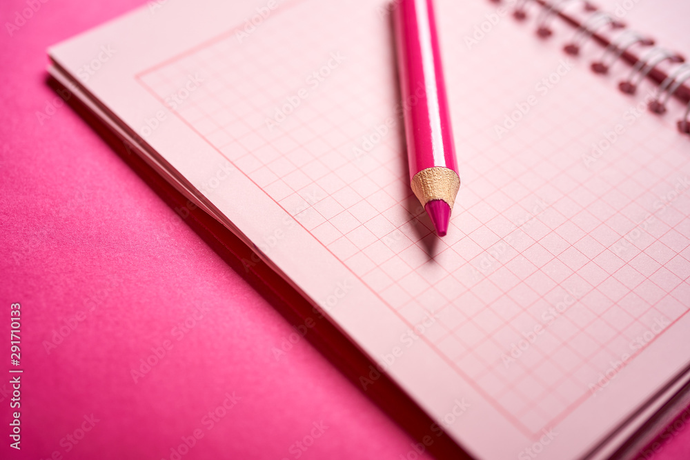 Close up of open notebook and pencil on blurred desk Close up of open notebook and pencil on blurred desk