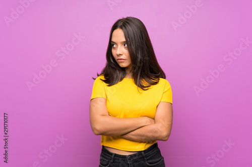 Young brunette girl over isolated background portrait