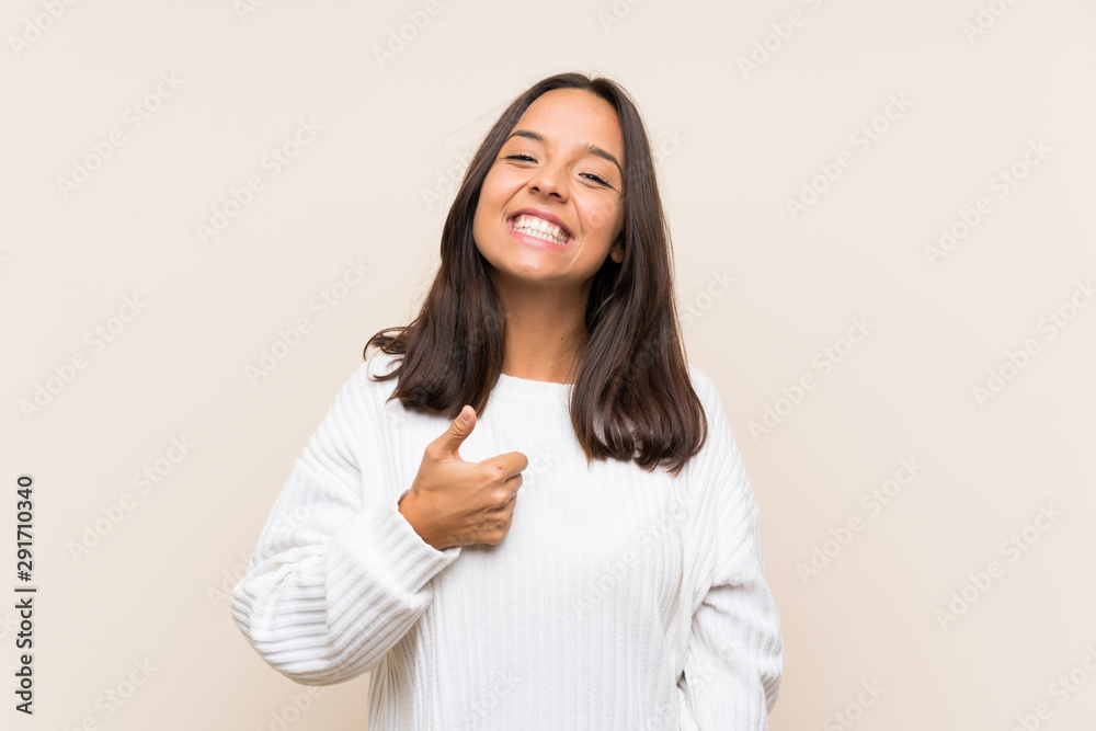 Young brunette woman with white sweater over isolated background giving a thumbs up gesture Young brunette woman with white sweater over isolated background giving a thumbs up gesture