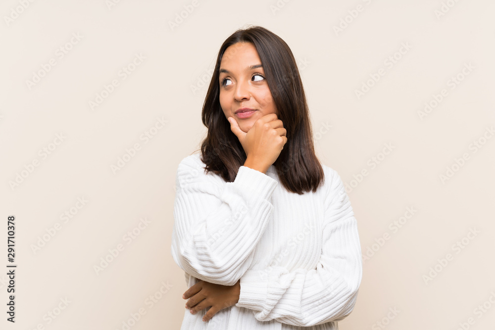 Young brunette woman with white sweater over isolated background thinking an idea Young brunette woman with white sweater over isolated background thinking an idea