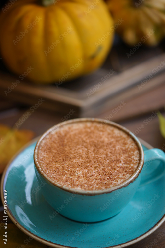 Cup of coffee with cinnamon on an open table Cup of coffee with cinnamon on an open table