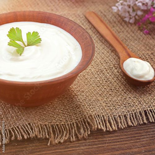 Bowl of Greek yogurt.Delicious breakfast. Homemade yogurt on a wooden tray, top view