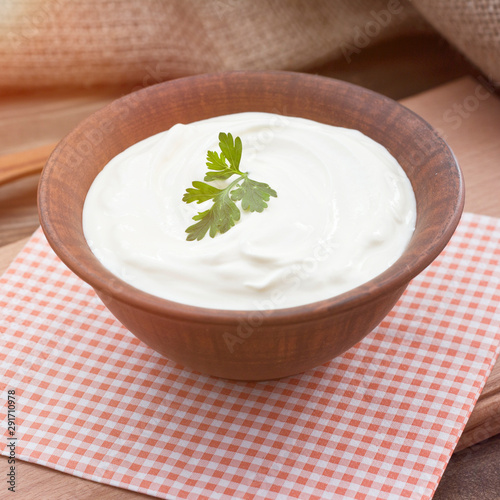 Bowl of Greek yogurt.Delicious breakfast. Homemade yogurt on a wooden tray, top view