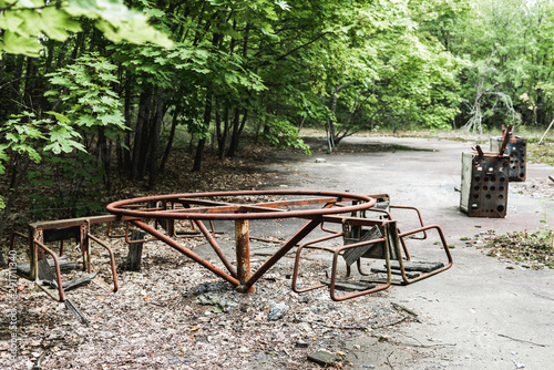 burnt baby doll on abandoned carousel in chernobyl photo