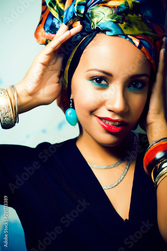 beauty bright african woman with creative make up, shawl on head like cubian closeup smiling photo