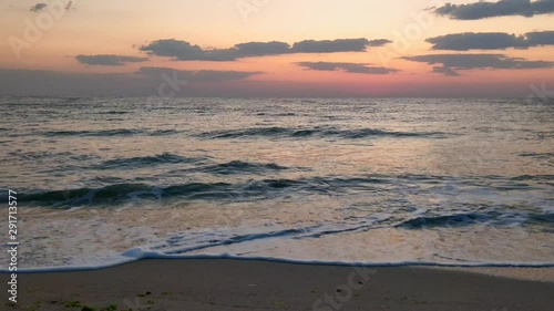 morning summer day at the seashore with waves breaking on the beach