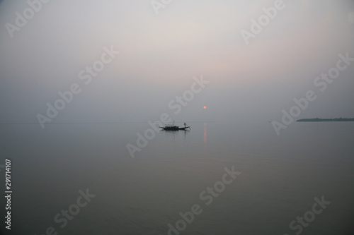 A stunning sunset looking over the holiest of rivers in India. Ganges delta in Sundarbans, West Bengal, India.