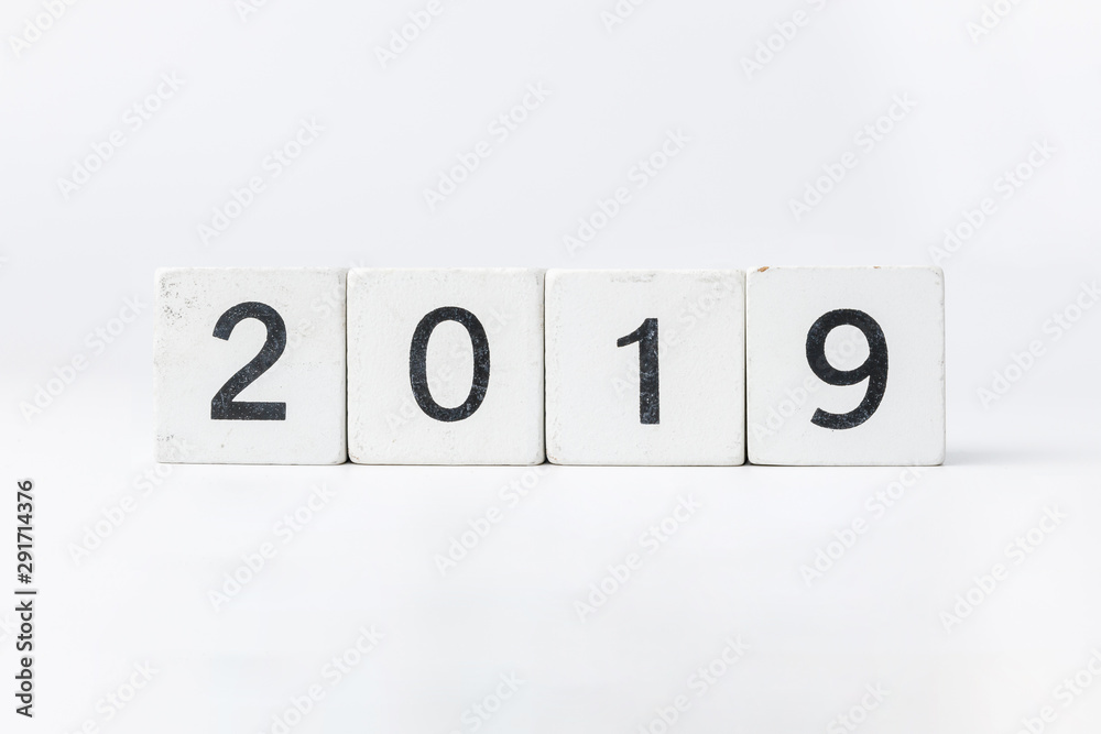 Business and design concept - geometric floating wooden cube on white background. 2019 years. Business and design concept - geometric floating wooden cube on white background. 2019 years.
