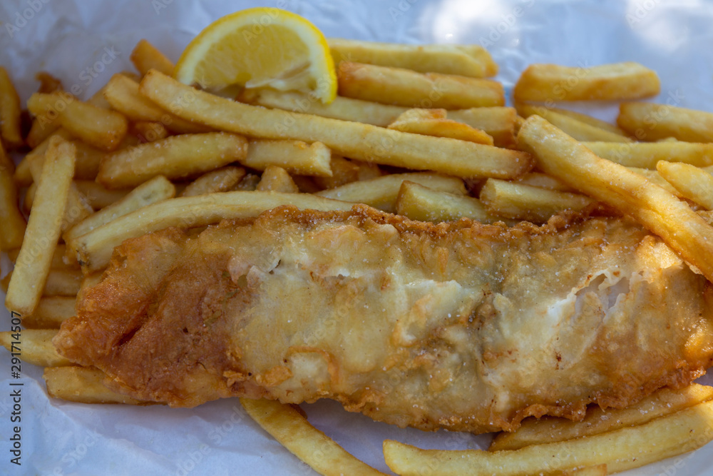 Beer battered Barramundi fish and chips  in traditional paper wrapping