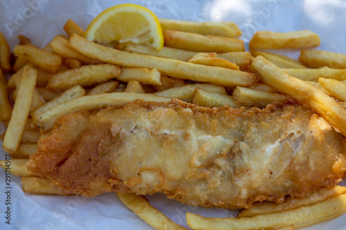 Beer battered Barramundi fish and chips  in traditional paper wrapping