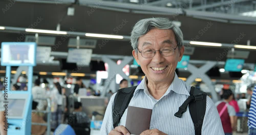 Portrait of senior man smiling at the flight timetable background in airport. Portrait of senior man smiling at the flight timetable background in airport.