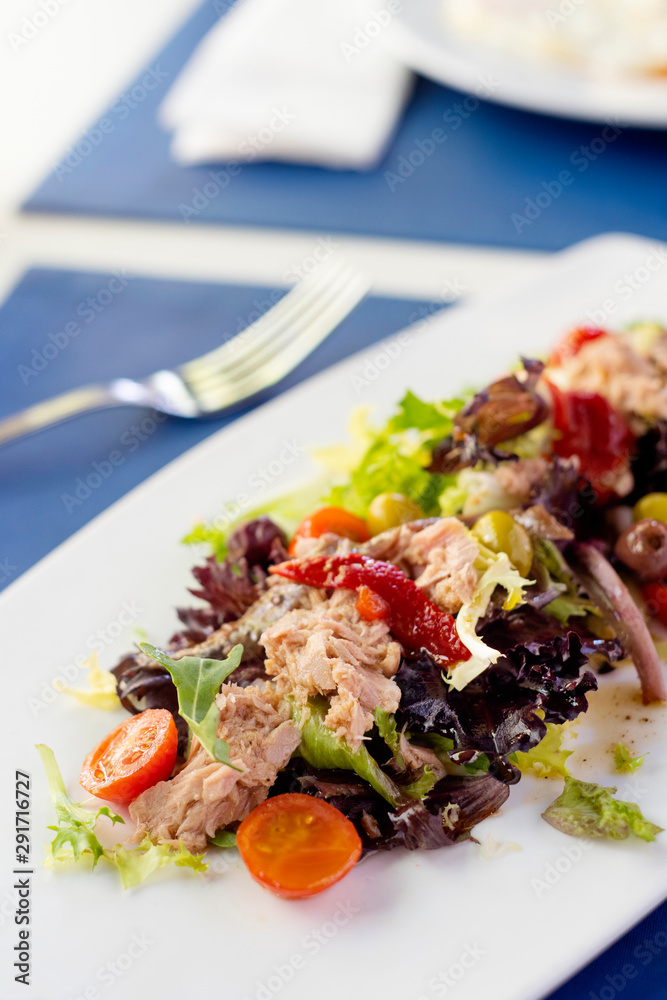 a plate with salad on a table a plate with salad on a table