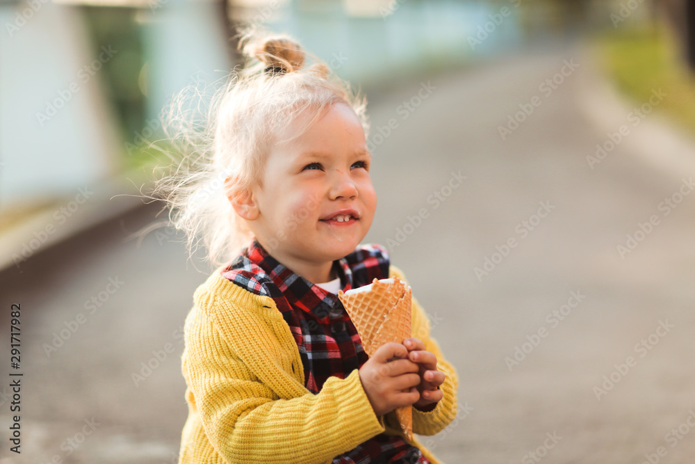 caucasian child blonde eating ice cream outside caucasian child blonde eating ice cream outside