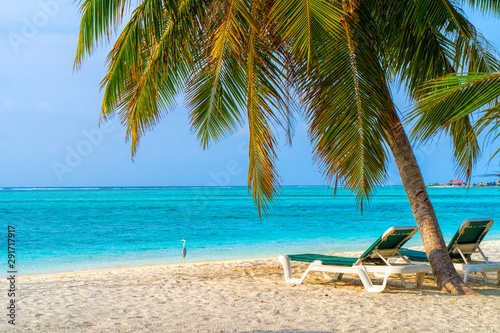 Lounge chairs on a beautiful tropical beach at Maldives