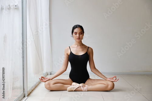 beautiful healthy asian woman in ballet dress enjoying in meditates with yoga pose at home with relaxation