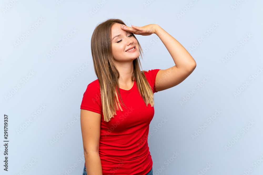 Teenager girl over isolated blue background laughing Teenager girl over isolated blue background laughing