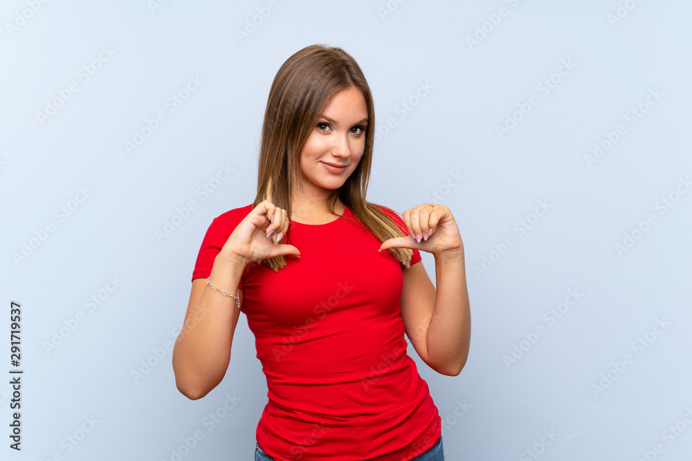 Teenager girl over isolated blue background proud and self-satisfied Teenager girl over isolated blue background proud and self-satisfied