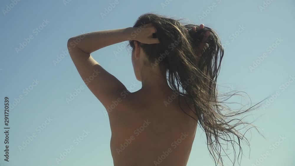 Girl shakes long hair. Woman moves long hair. Rear view. Female model is fluttering hair. Slow motion footage. Girl shakes long hair. Woman moves long hair. Rear view. Female model is fluttering hair. Slow motion footage.