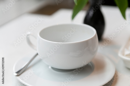 Fototapeta Naklejka Na Ścianę i Meble -  White empty tea cup in restaurant 