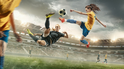 Excitement. Young female soccer or football players in sportwear kicking ball for the goal in action at the stadium. Concept of healthy lifestyle, sport, motion, movement. Collage made of 2 models. © master1305