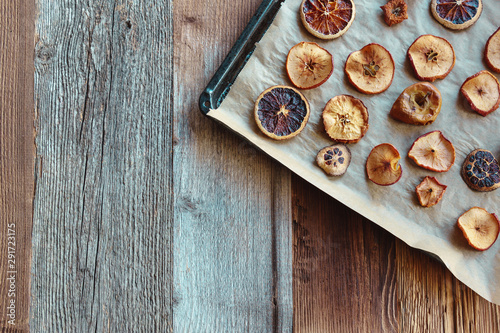 Homemade slices of dried apples and oranges (flat lay, copy space)