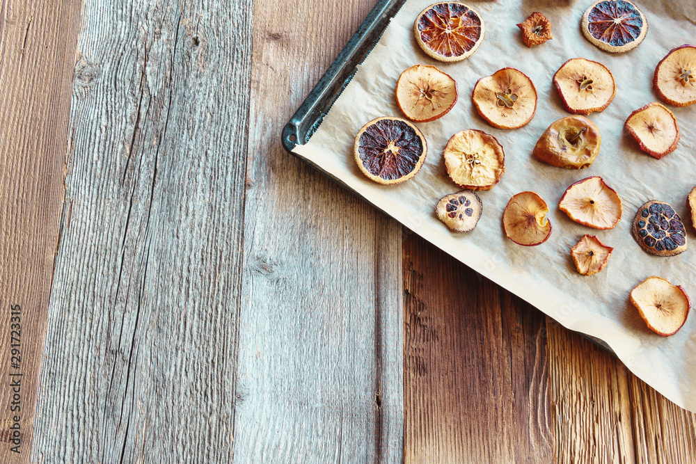 Homemade slices of dried apples and oranges (angled view, copy space) Homemade slices of dried apples and oranges (angled view, copy space)