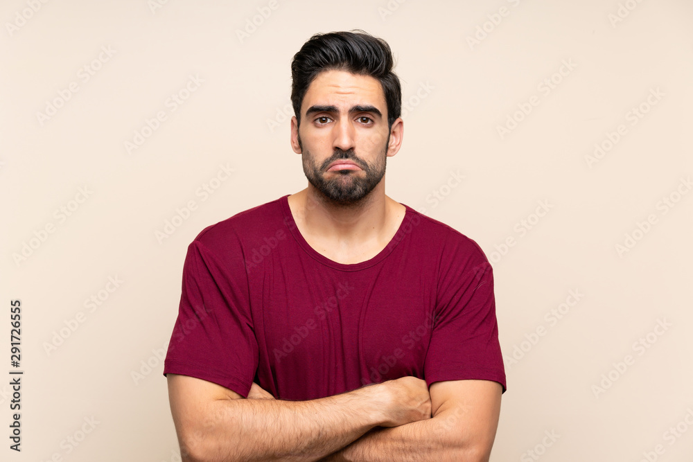 Handsome young man over isolated background sad Handsome young man over isolated background sad
