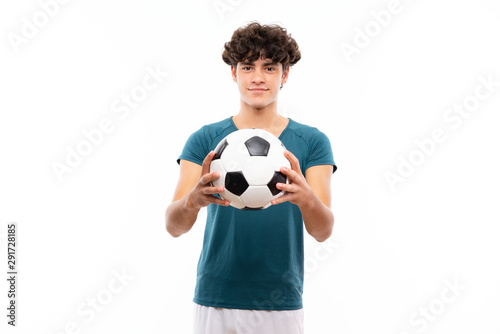 Young football player man over isolated white wall © luismolinero