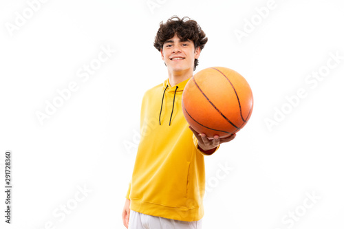 Young basketball player man over isolated white wall