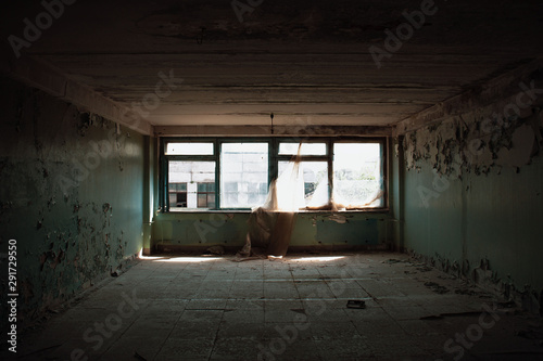 Old empty dirty grunge room with big windows in abandoned house or building inside