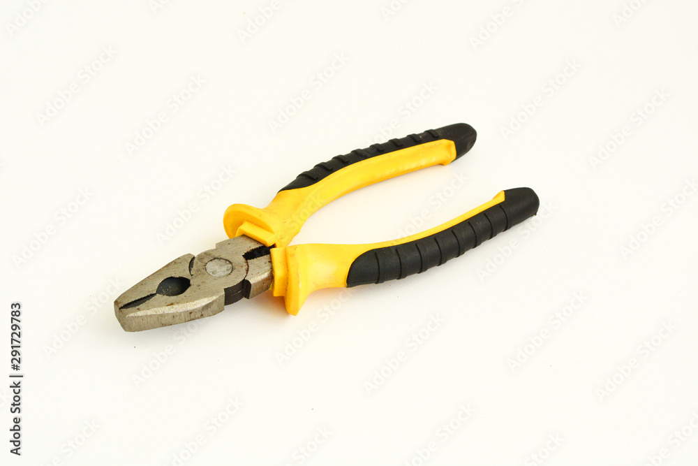 metal pliers with rubber handles black and yellow color isolated on white background. Repair or building concept metal pliers with rubber handles black and yellow color isolated on white background. Repair or building concept