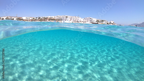 Sea level and underwater photo of tropical exotic sandy beach with turquoise clear sea in popular Caribbean destination