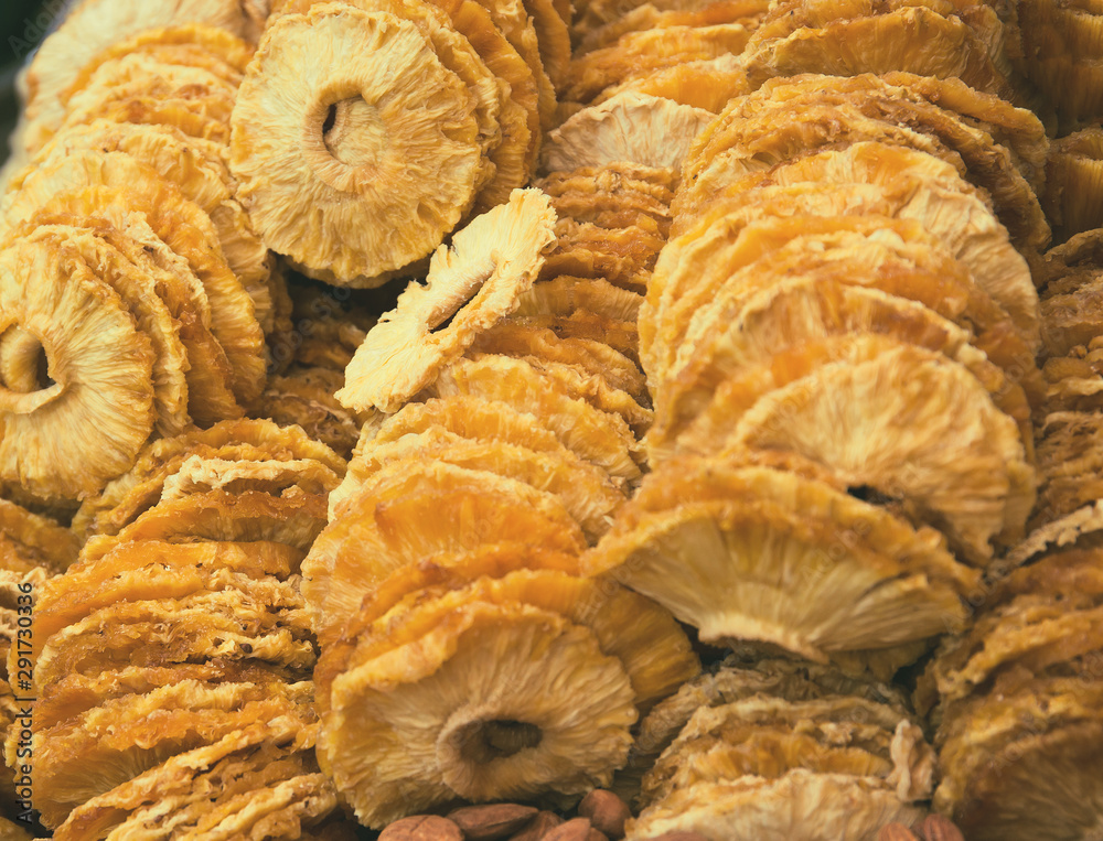 Slices of dried pineapple at the market close up. Tasty snack suitable for vegeterians and vegans. Slices of dried pineapple at the market close up. Tasty snack suitable for vegeterians and vegans.