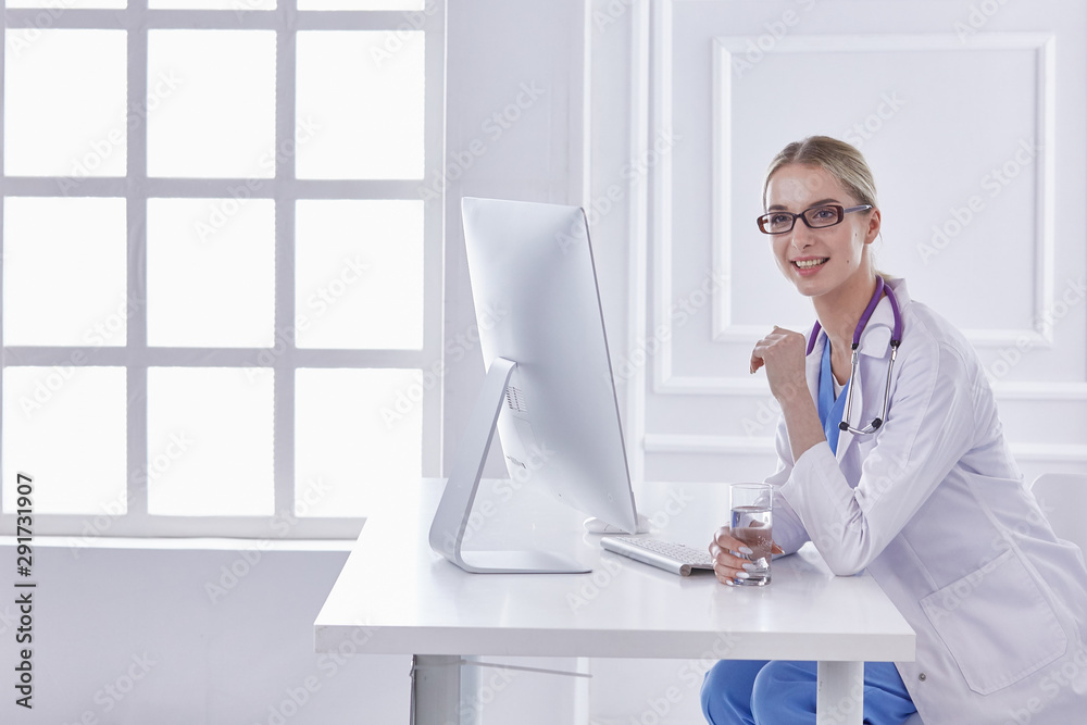 Portrait of a happy smiling young doctor in headset in office Portrait of a happy smiling young doctor in headset in office