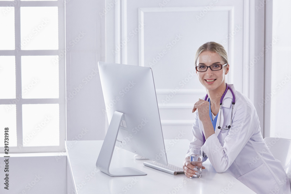 Portrait of a happy smiling young doctor in headset in office Portrait of a happy smiling young doctor in headset in office