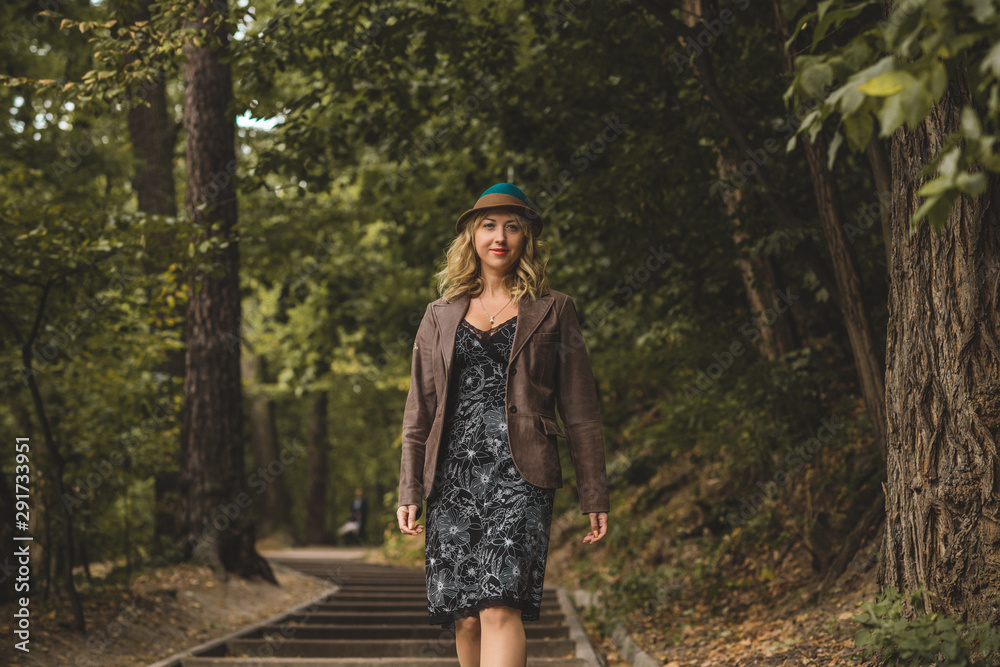 Lady walk in autumn park, fashionable woman in casual style outdoors portrait Lady walk in autumn park, fashionable woman in casual style outdoors portrait