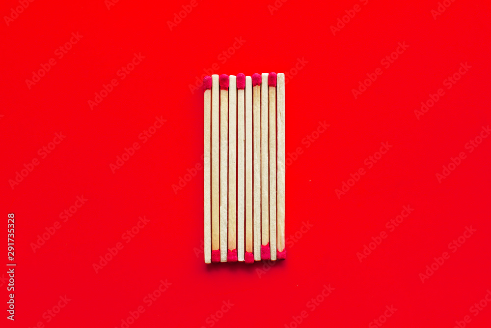 Matches for danger concept on red background top view Matches for danger concept on red background top view