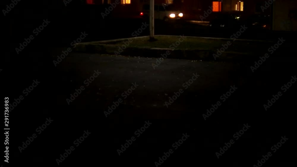 A lamp blinks in the night city. Electricity problems. Old lamp on the street in a dark city A lamp blinks in the night city. Electricity problems. Old lamp on the street in a dark city