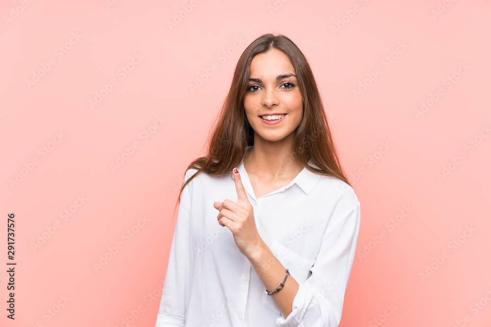 Young woman over isolated pink background pointing with the index finger a great idea Young woman over isolated pink background pointing with the index finger a great idea