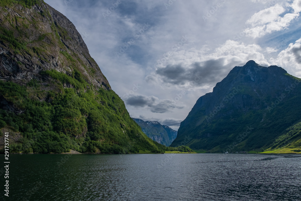 Mountains and Neroyfjord(Sognefjord) in Norway. Clouds and blue sky. July 2019