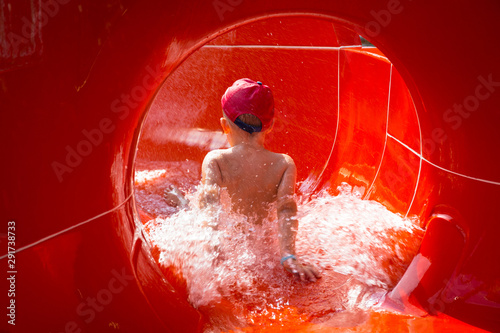 Valokuva Little boy at the water slide on sun holidays