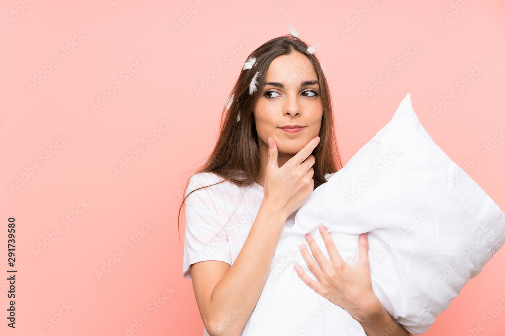 Young woman in pajamas over isolated pink background thinking an idea Young woman in pajamas over isolated pink background thinking an idea