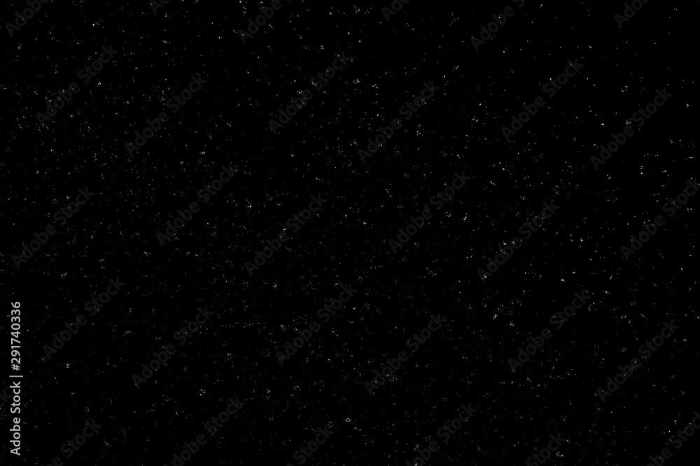 Chaotic white bokeh on a black background, light spots texture, abstraction, falling snow, starry sky, bright glare of light texture
