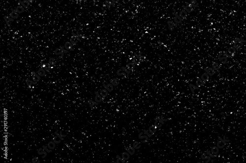 Chaotic white bokeh on a black background, light spots texture, abstraction, falling snow, starry sky, bright glare of light texture