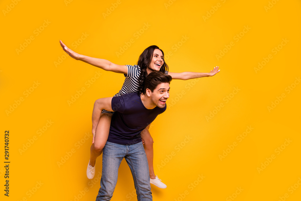 Photo of style stylish trendy cheerful nice cute couple of two people wearing t-shirt dress pretending to fly while isolated with background yellow Photo of style stylish trendy cheerful nice cute couple of two people wearing t-shirt dress pretending to fly while isolated with background yellow