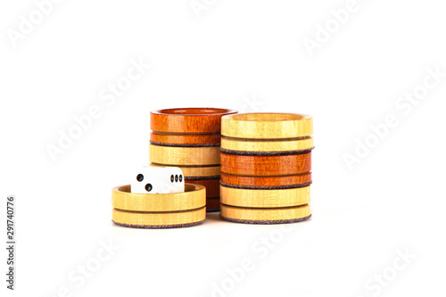 Dice and backgammon checkers isolated on a white background.