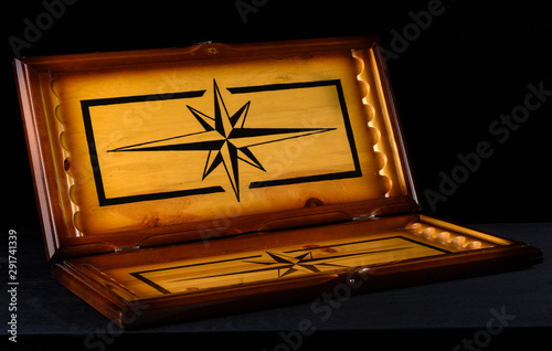 Open backgammon board over a dark background.