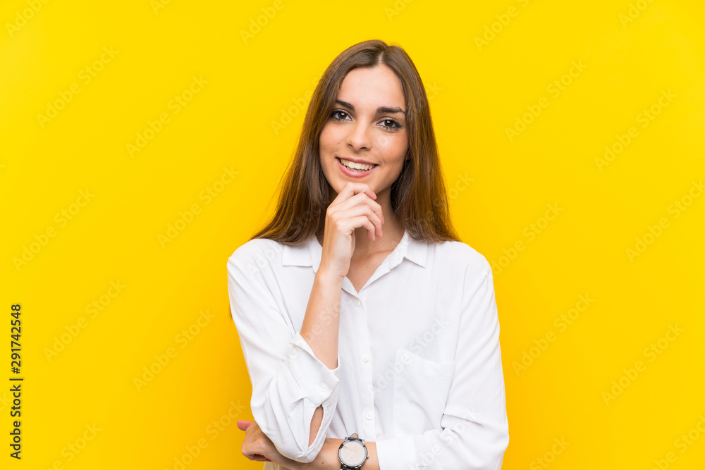 Young woman over isolated yellow background laughing Young woman over isolated yellow background laughing