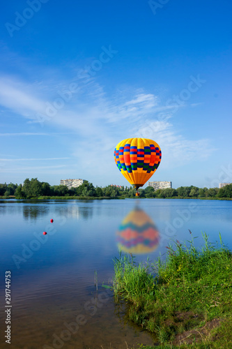 Balloon over the lake with reflection.